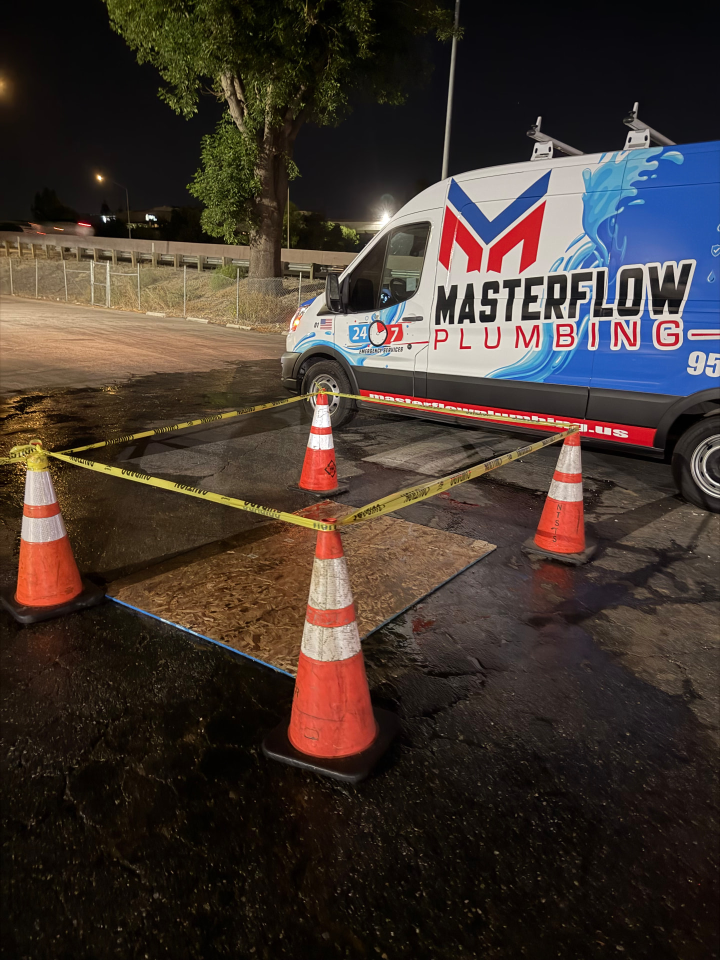 Masterflow Plumbing van at emergency pipe burst job site with cones and caution tape