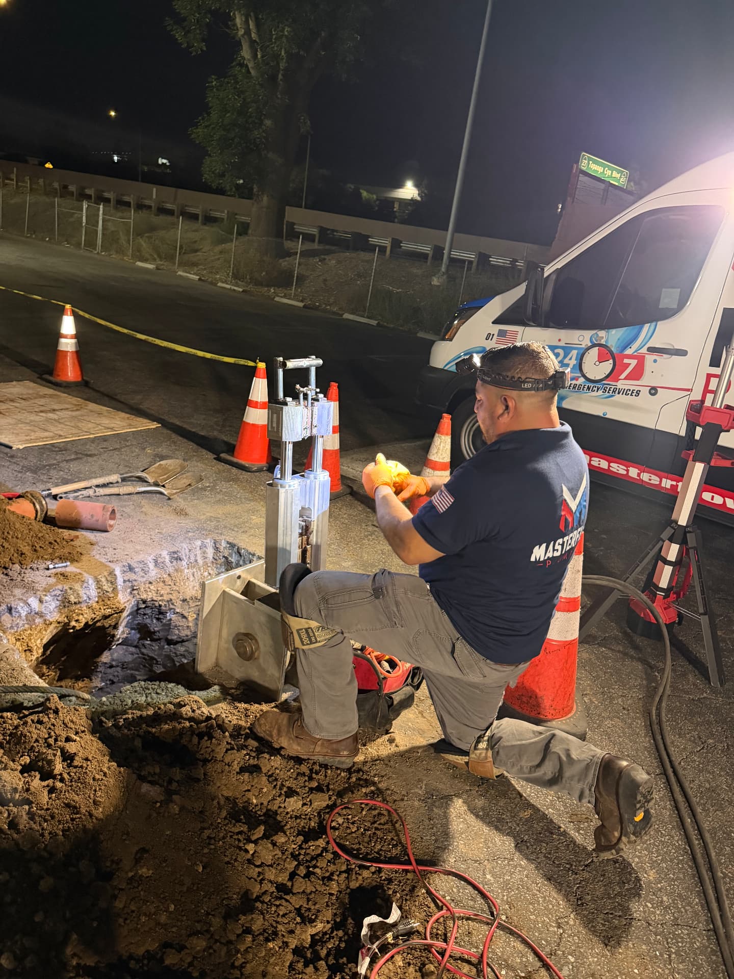 Masterflow technician repairing a burst underground water line at night